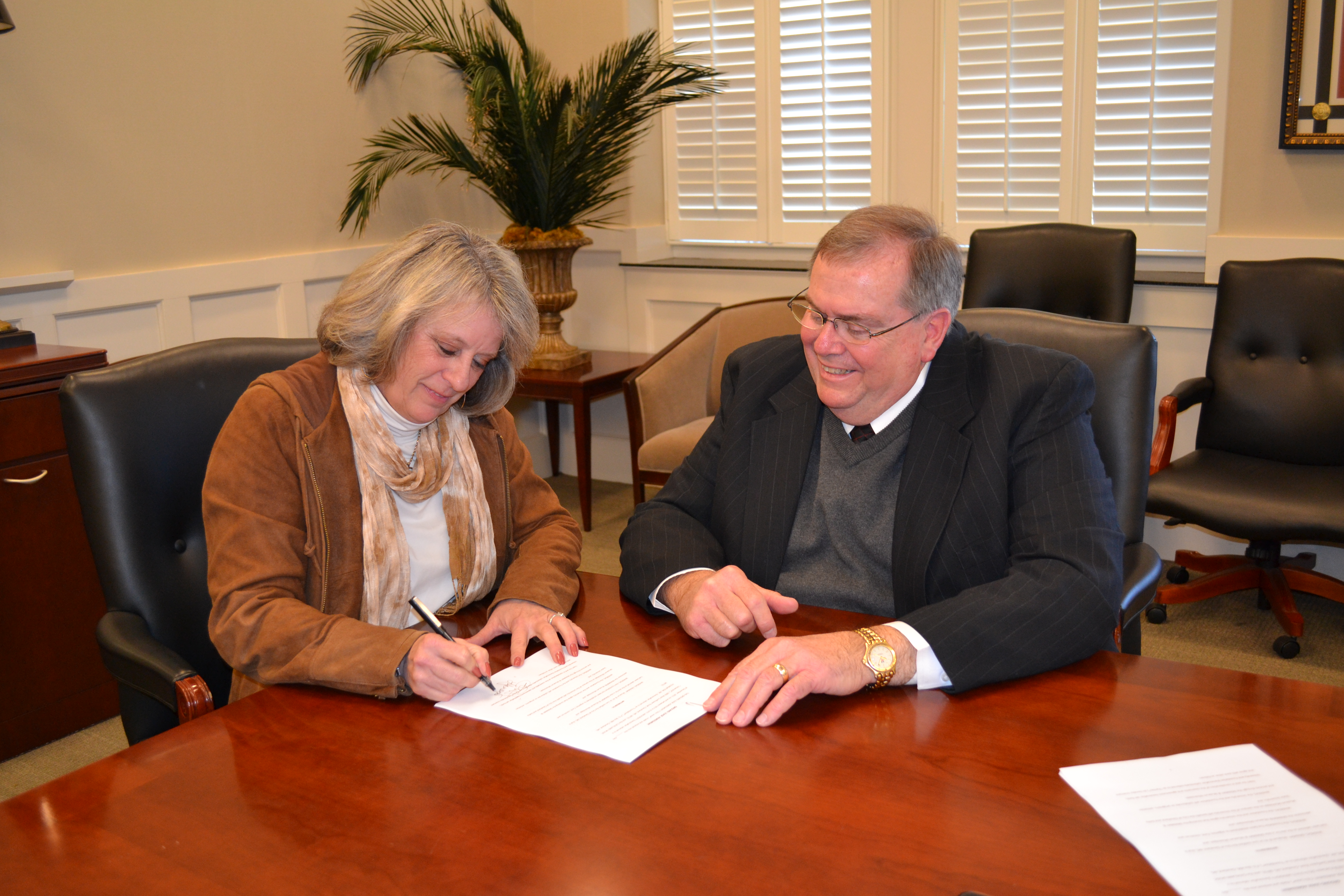 PHOTO:  From left, President of the Cleveland Music Foundation Lucy Janoush and Delta State University President Dr. John M. Hilpert sign the lease agreement for the establishment of GRAMMY® Museum Mississippi to be located on the Delta State University campus in Cleveland. 